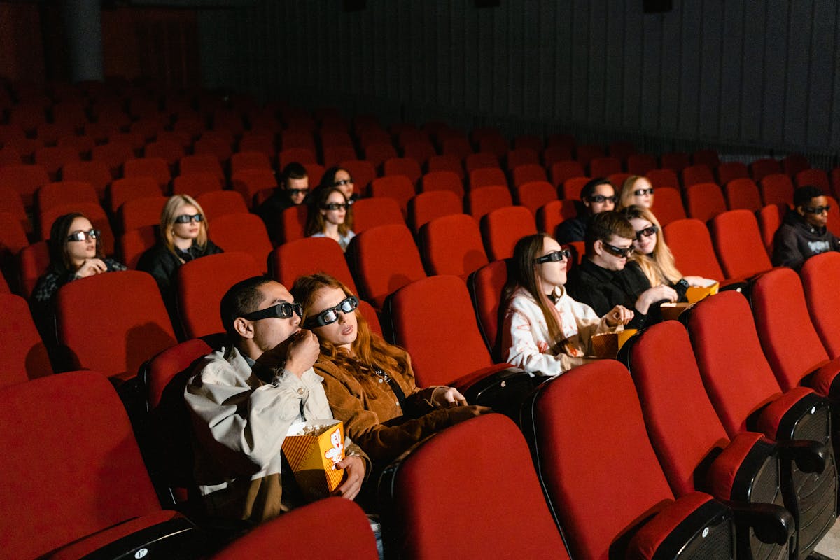 Audience seated in a modern cinema watching a new film premiere