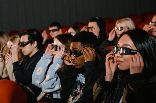People Wearing 3D Glasses inside a Cinema