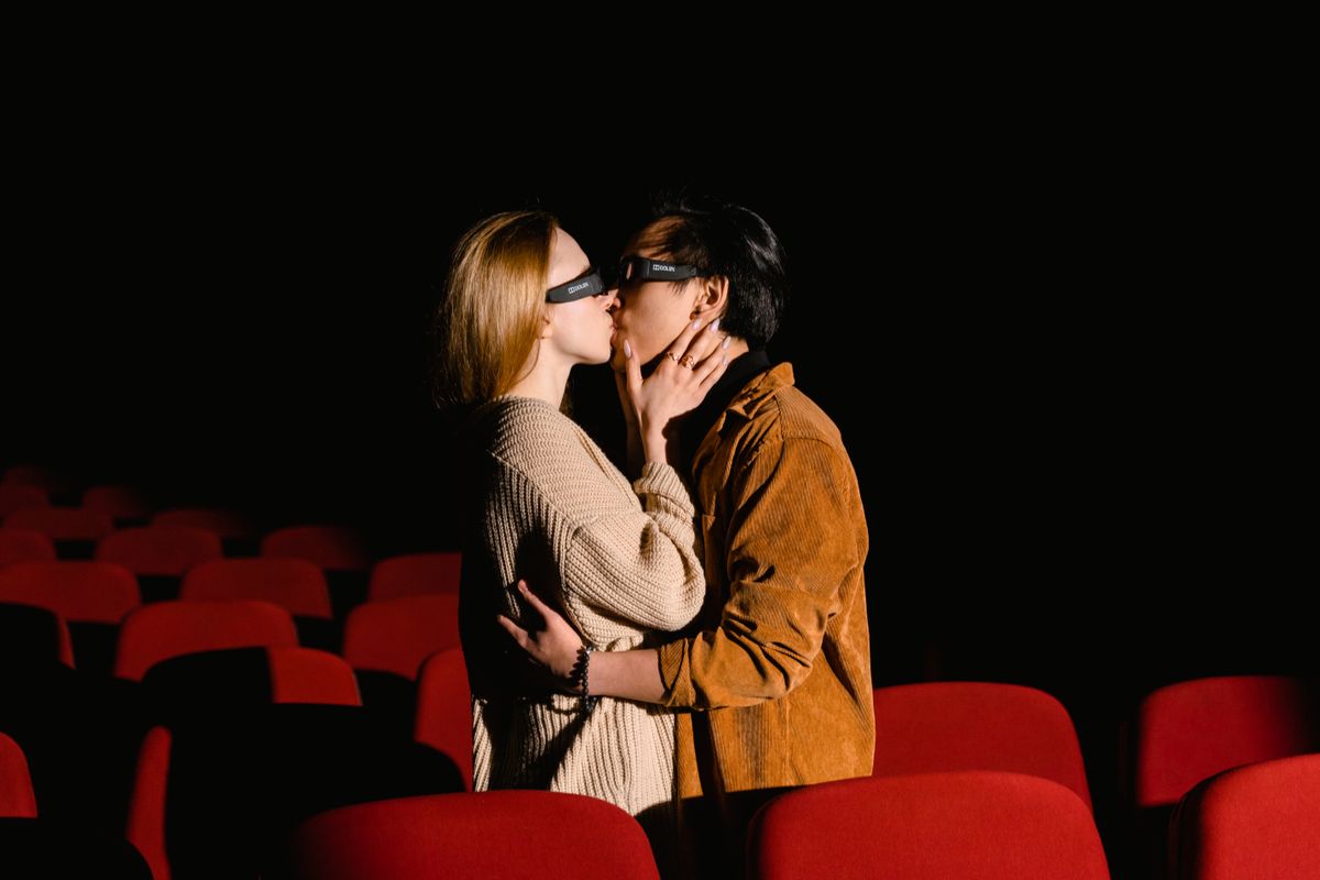 People buying movie tickets at a modern cinema box office