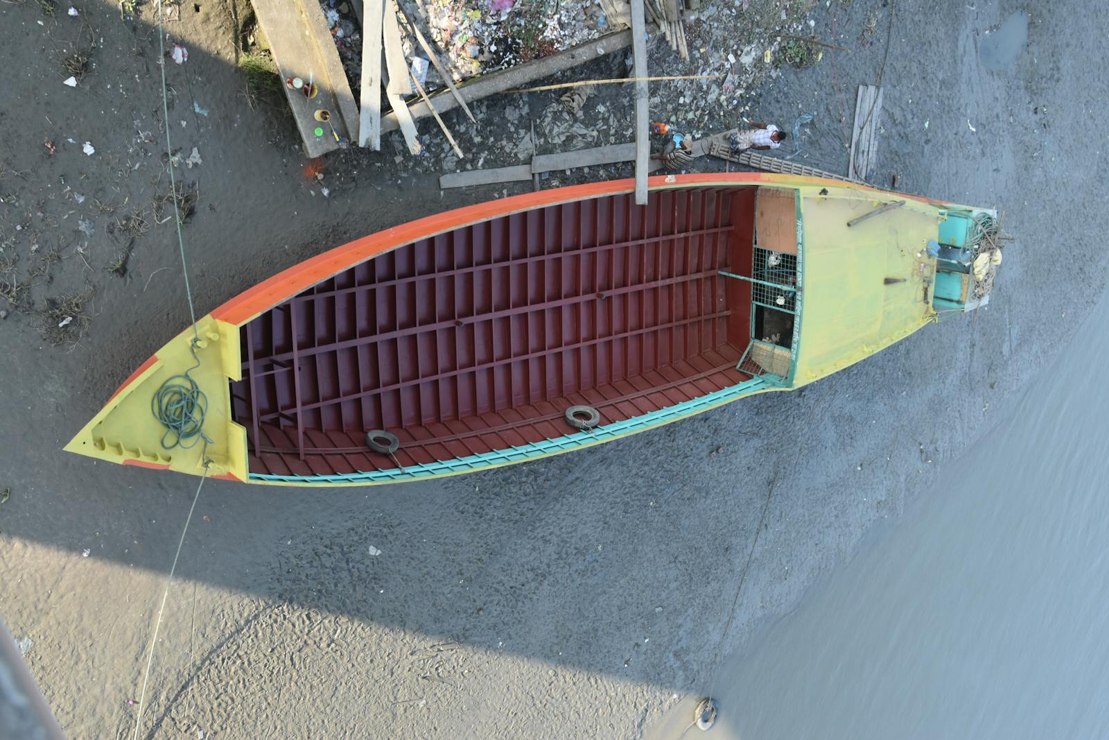 Old VHS tapes and DVDs of 1990s action movies stacked on a table