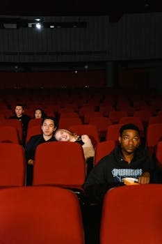 A group of diverse people enjoying a cinema experience in a theater.