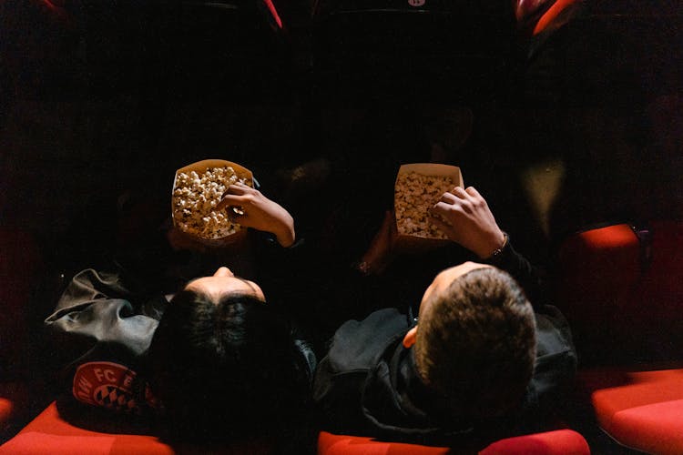 People Eating Popcorn At A Cinema