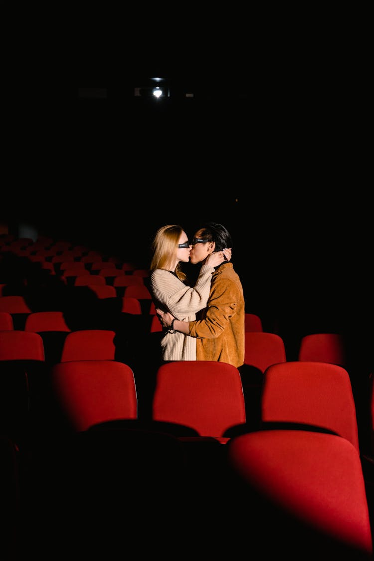 A Couple Kissing At The Movie Theater