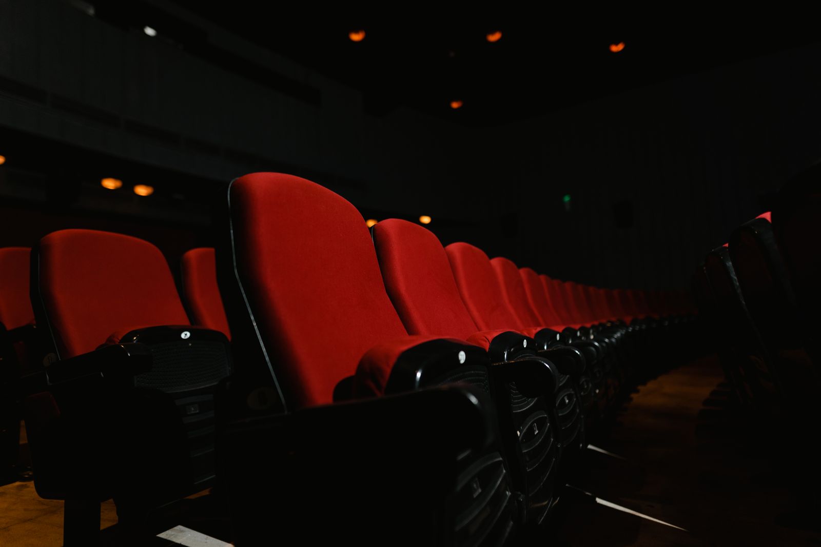 Very dark theater interior with tiered seating