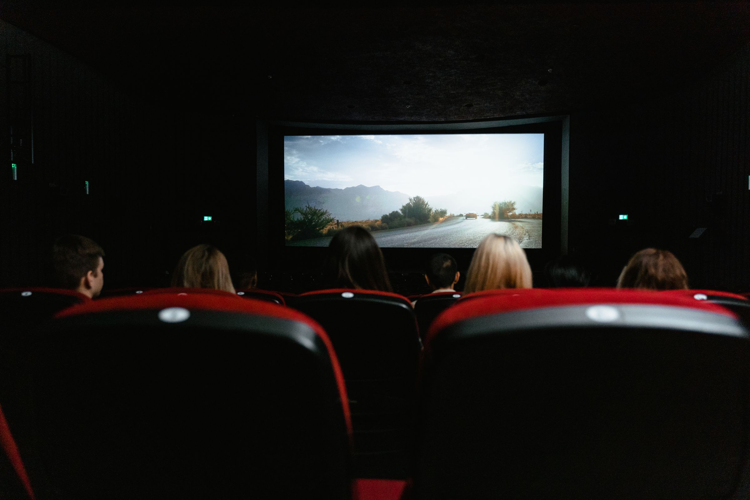Audience watching a film together in a dark cinema