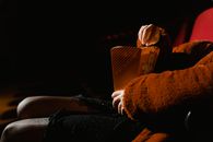Person in Brown Hoodie Holding Black Smartphone