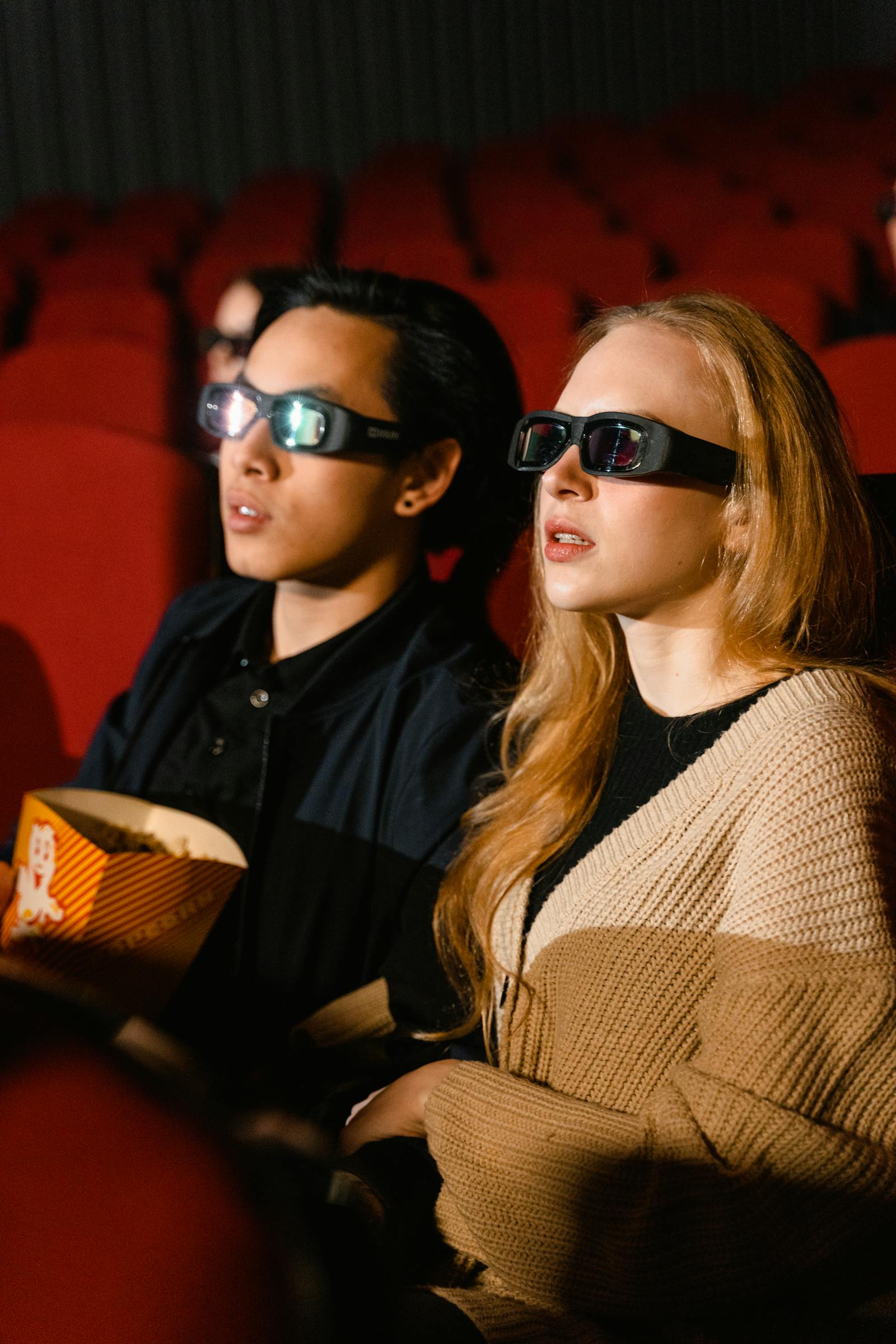 Film projector casting light in a dark cinema
