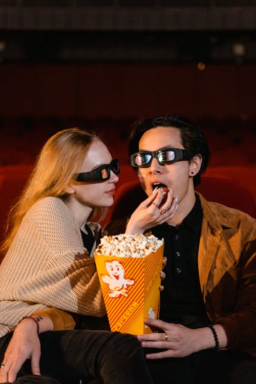 Free A Couple Eating Popcorn Stock Photo