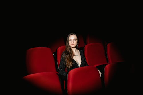 Free A Woman Sitting in the Movie Theater Stock Photo