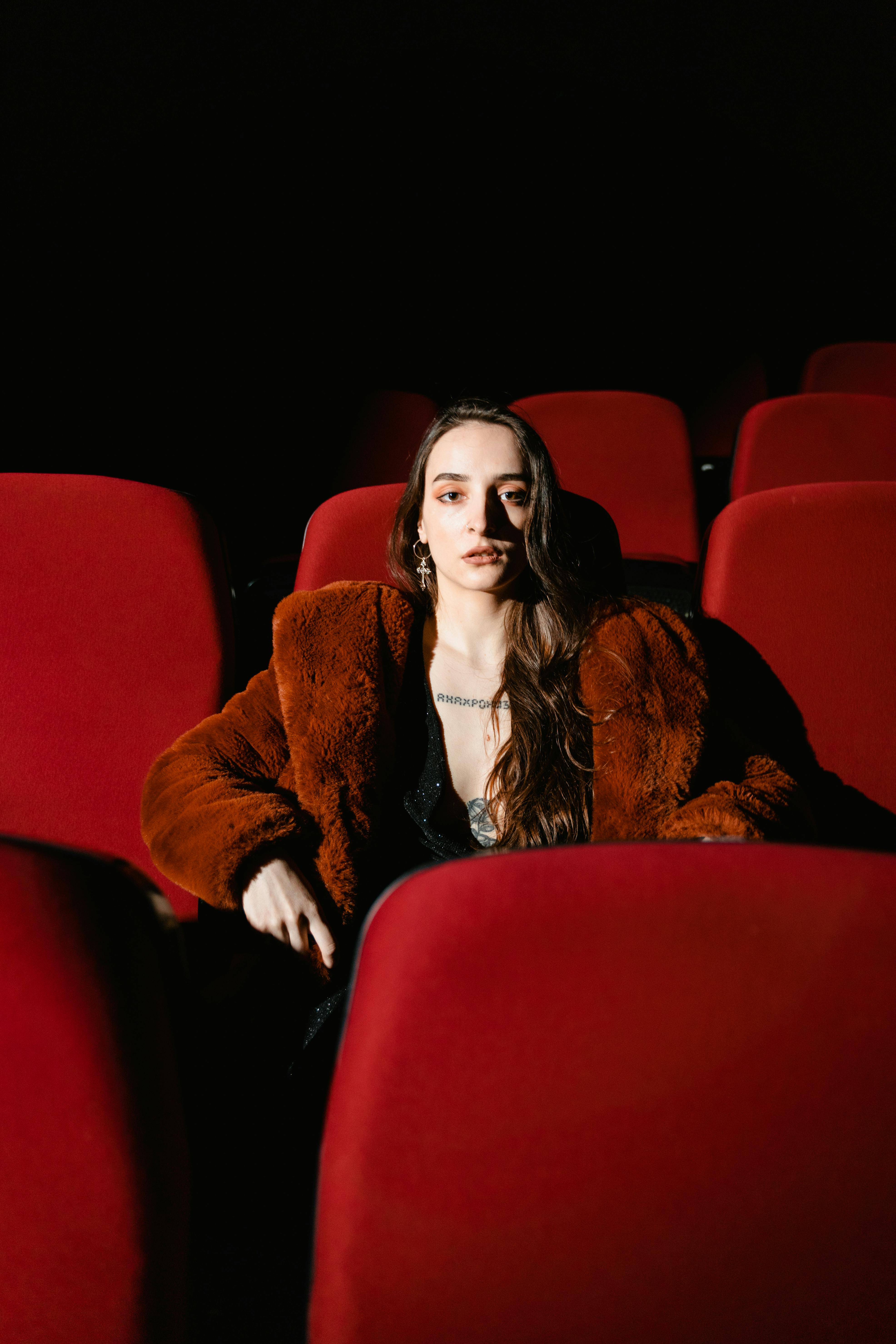 Woman in Brown Fur Coat Sitting on Red Chair · Free Stock Photo
