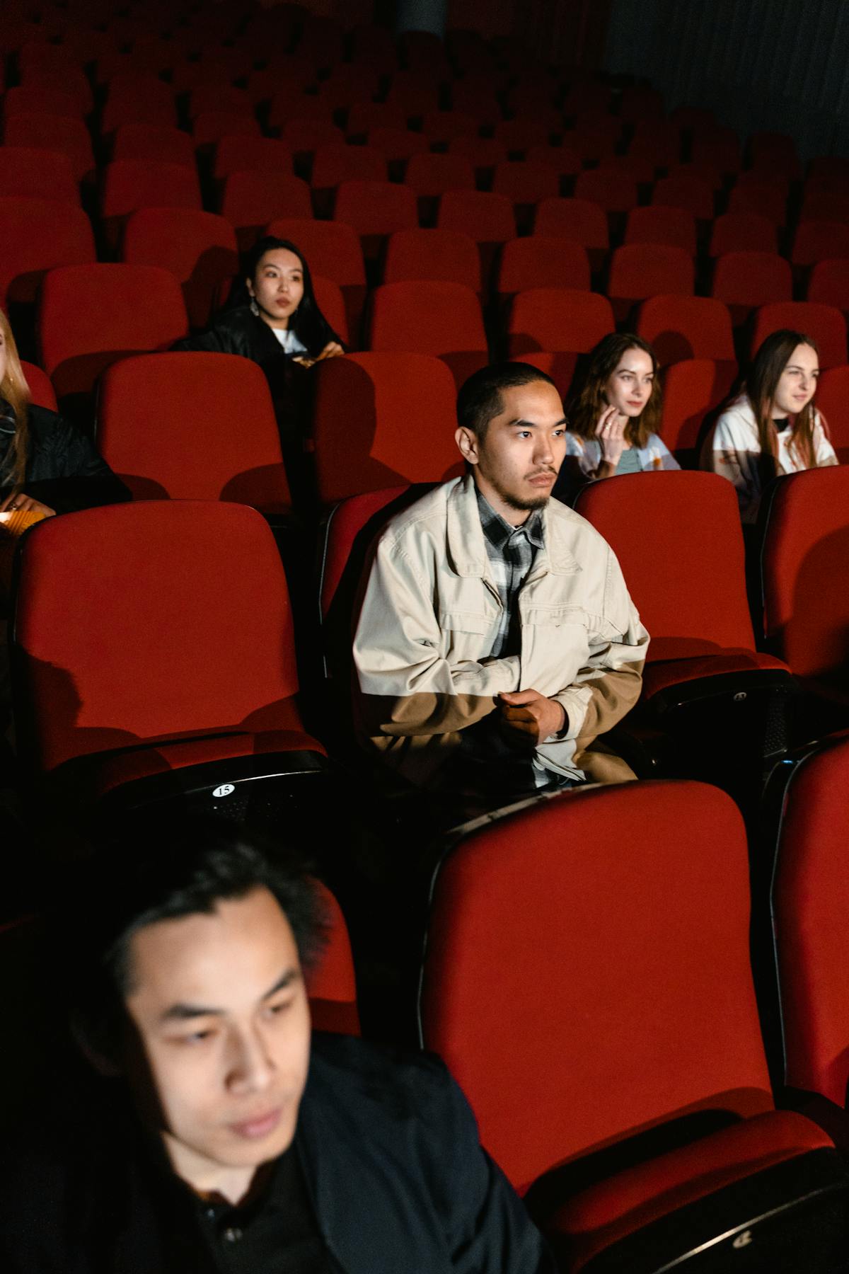 A movie theater audience watching a bright animated film on the big screen