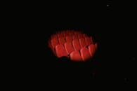 A Light Cast on Red Chairs in a Dark Room