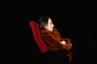 Woman in Red Sweater Sitting on Red Chair