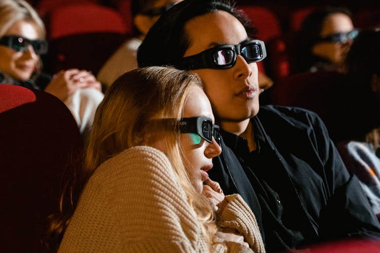 A Couple Sitting In A Movie Theater