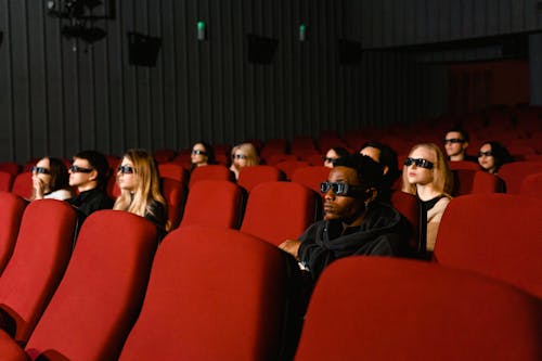 Free People Watching Movie while Wearing 3D Glasses Stock Photo