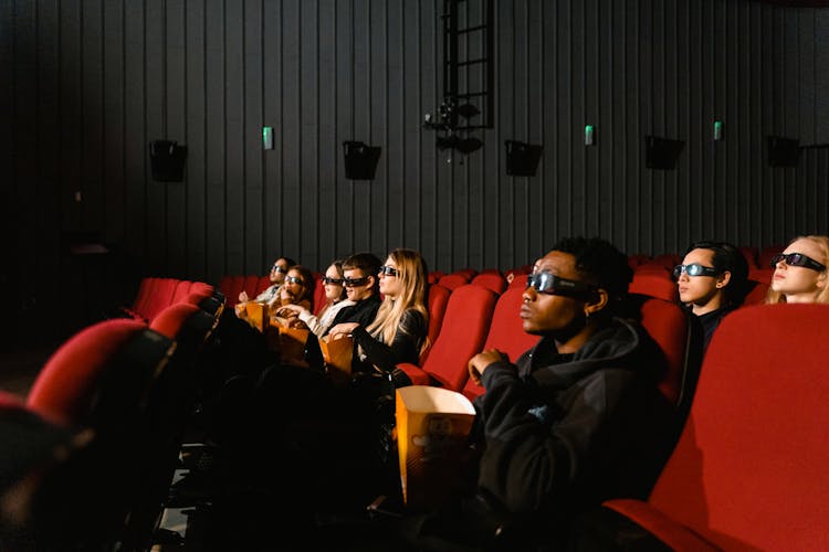 People Wearing 3d Glasses Watching A Movie