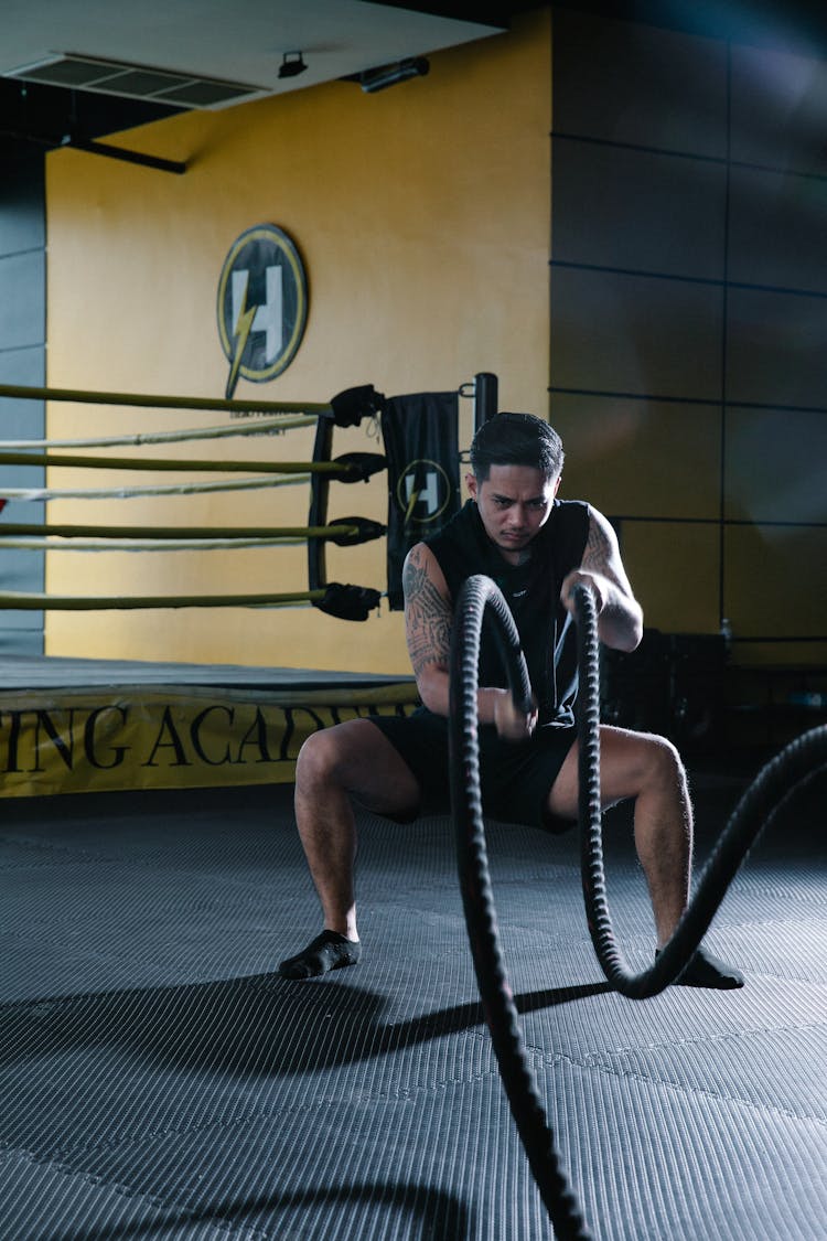 Man In Black Sports Wear Doing Battle Rope Work Out