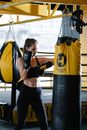 Woman with Boxing Gloves Hitting Punching Bag