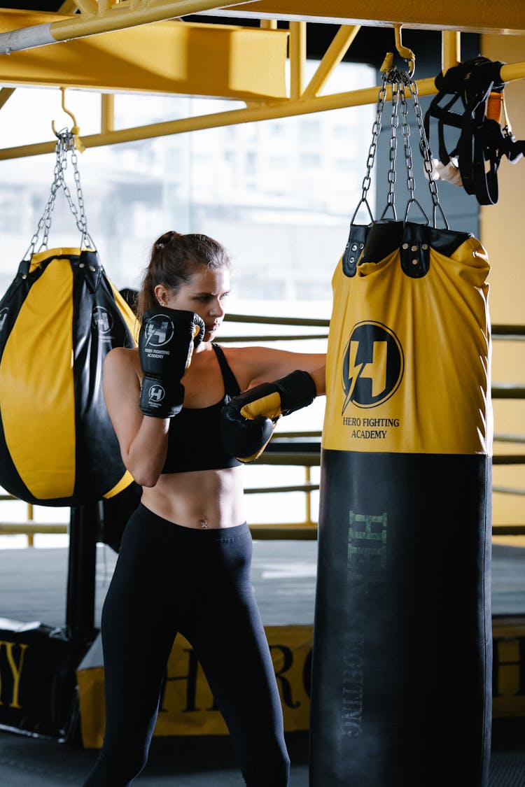 Woman With Boxing Gloves Hitting Punching Bag