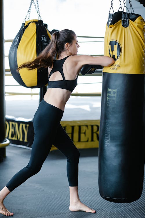 Free Fit woman punching boxing bag Stock Photo