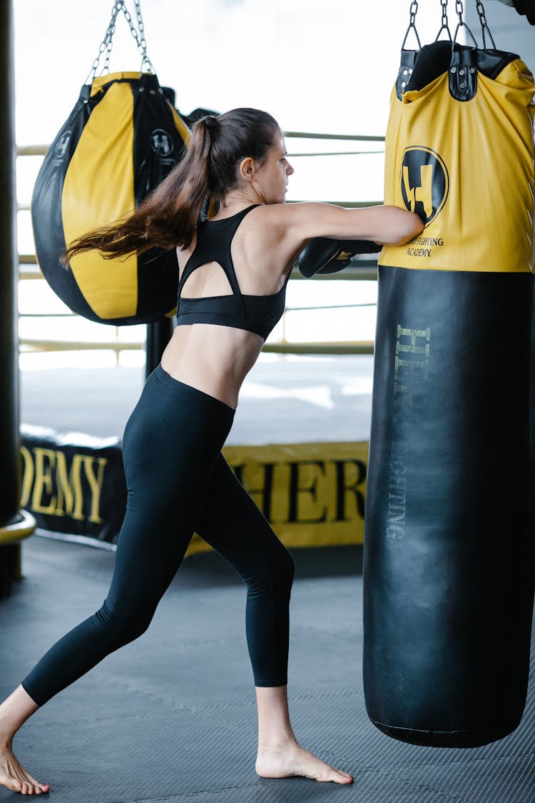 Fit Woman Punching Boxing Bag