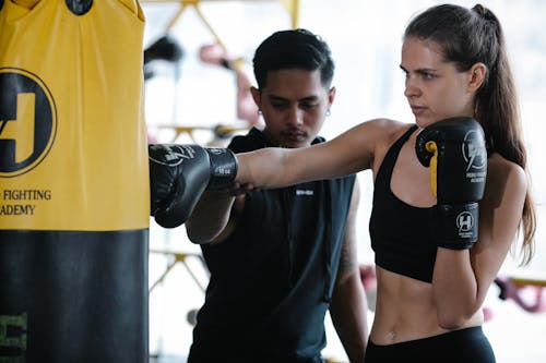 Free Man Training Woman How to Punch  Stock Photo
