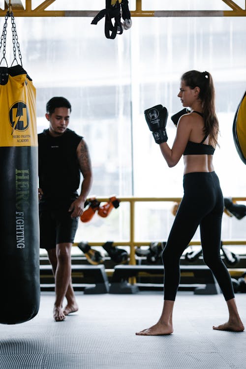 Free Woman training boxing with Latin American trainer Stock Photo