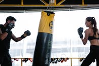 Man Training Woman in Boxing