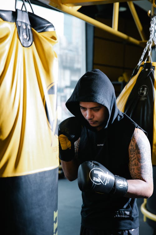Focused Latin American boxer training in club