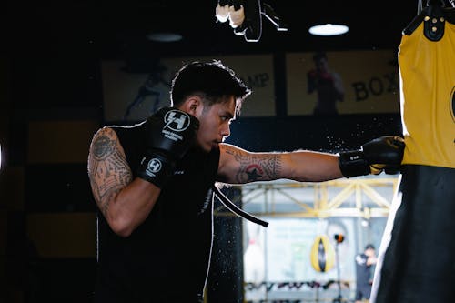 Athlete hitting heavy bag while practicing box