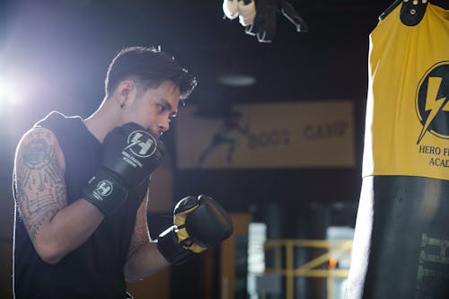 Boxer with punching bag during workout