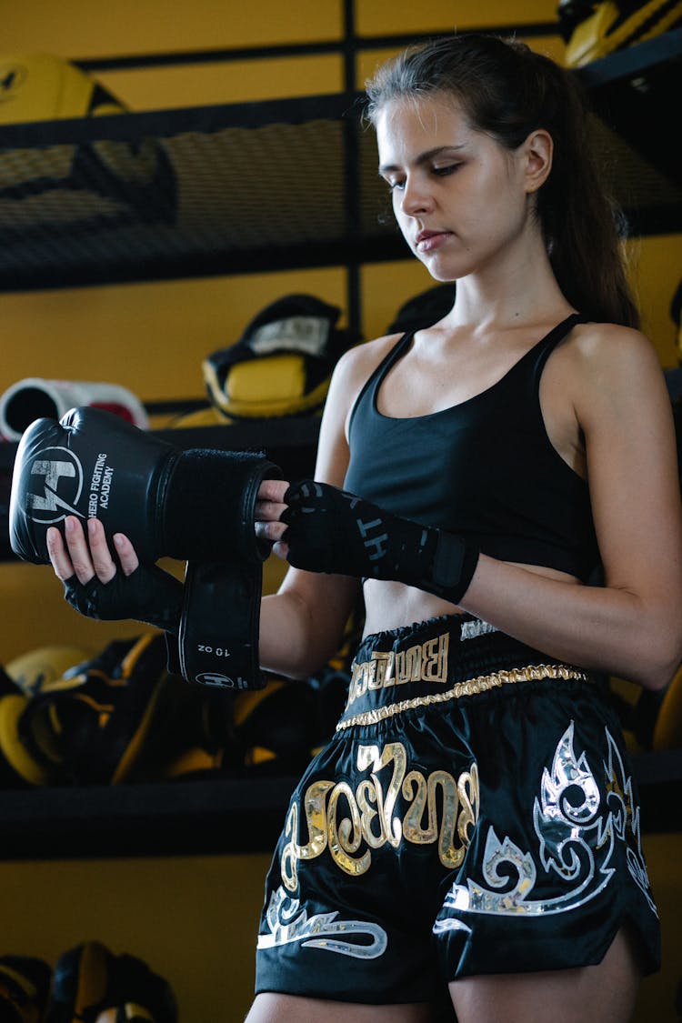 Sporty Woman Taking Boxing Glove Off