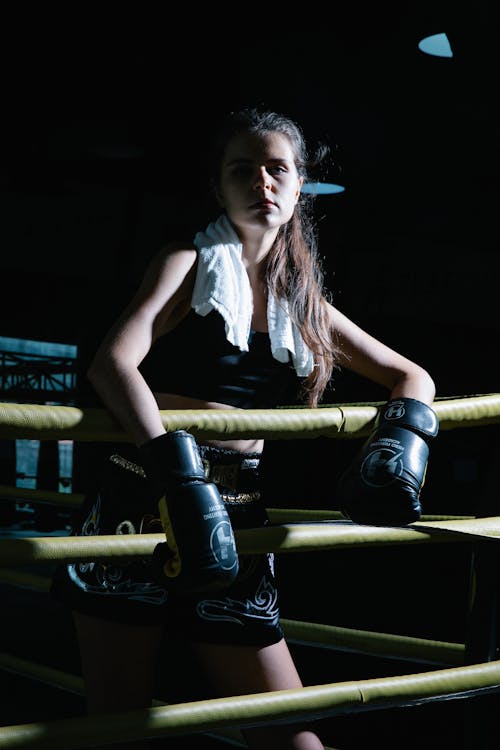 Female athlete standing on boxing ring