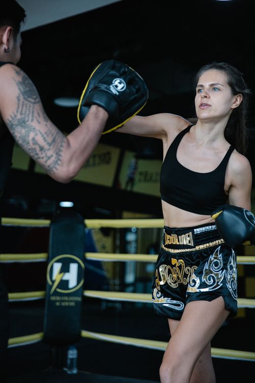 Free Young female boxer training in the ring, showcasing powerful moves and focus. Stock Photo