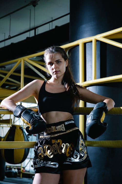 A Woman Leaning on the Edge of a Boxing Ring
