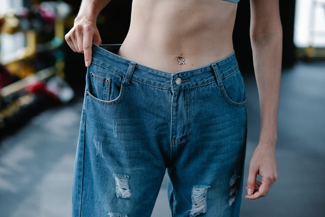 Free Close-up of Woman Wearing Loose Pants after Diet Stock Photo