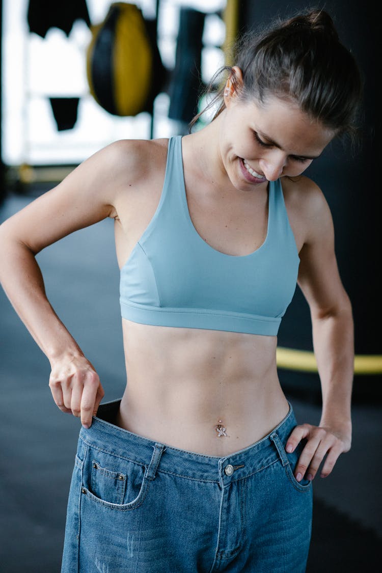 Athletic Woman Trying On Old Jeans