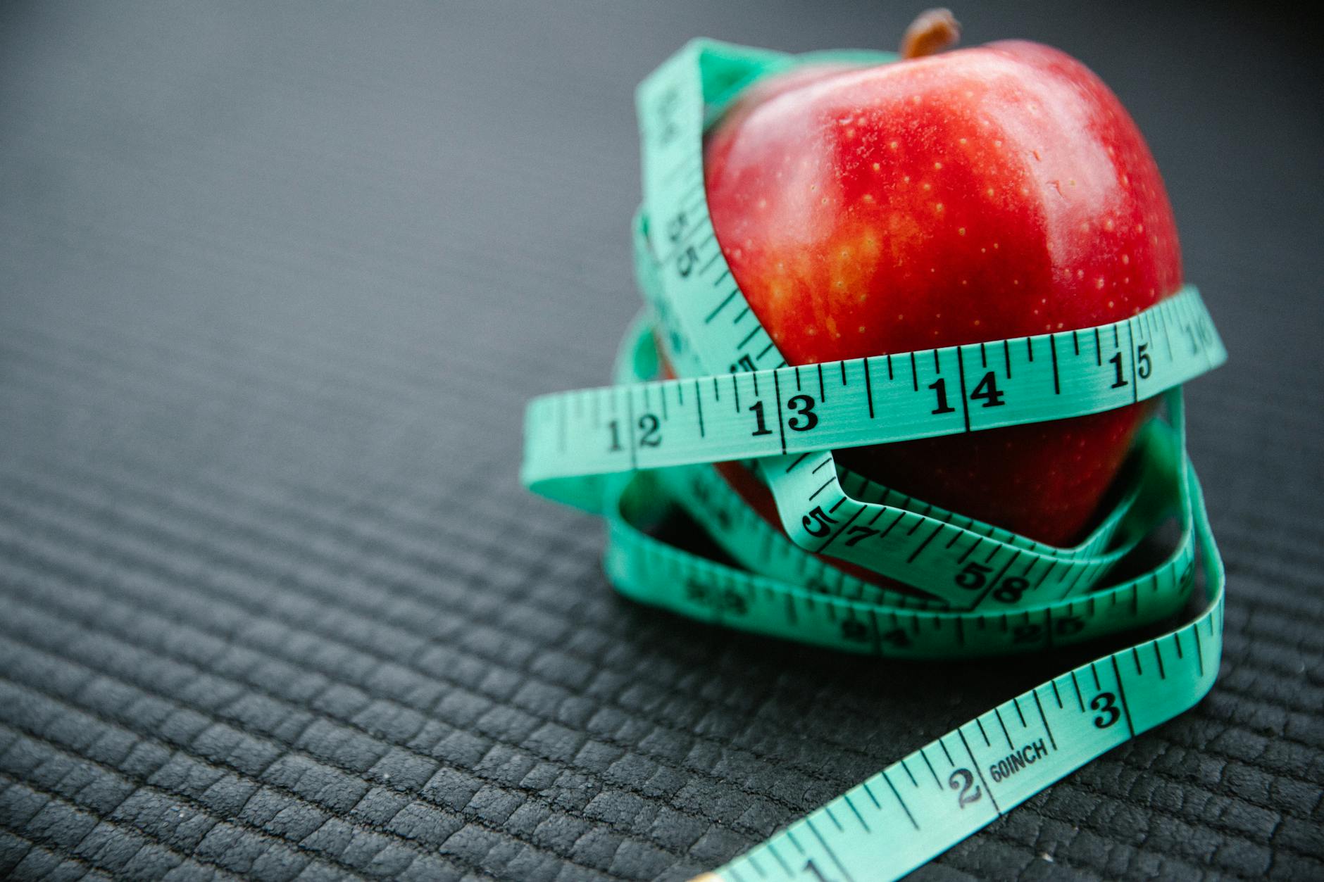 https://www.pexels.com/photo/measuring-tape-wrapped-around-red-apple-7991936/