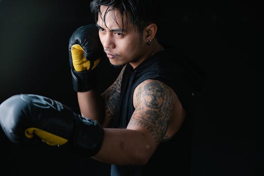 Close-up of a boxer practicing punch technique, wearing gloves and focused on training.