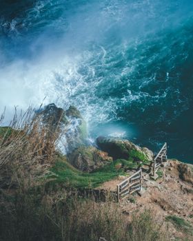 Stunning aerial view of a rocky waterfall with vibrant blue waters in Antalya, Türkiye.