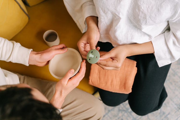 A Person Holding A Pacifier