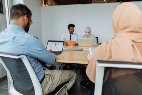 Free A diverse group of colleagues engaged in a business meeting in a modern office setting. Stock Photo