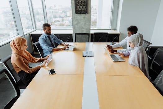 A diverse group of professionals working together in an office meeting room.