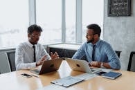 Men With Laptop Discussing With Each Other