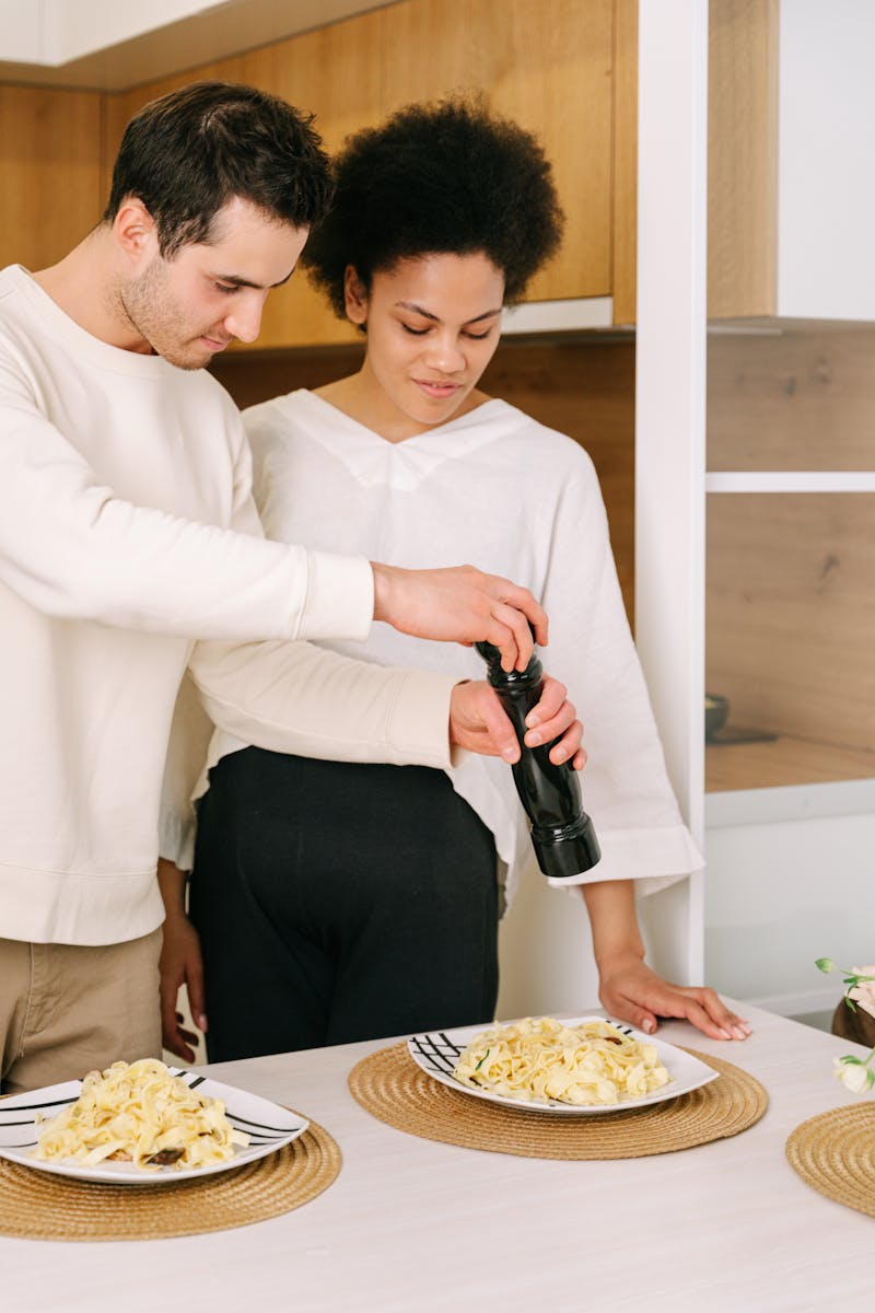 Man and Woman Standing beside Dining Table