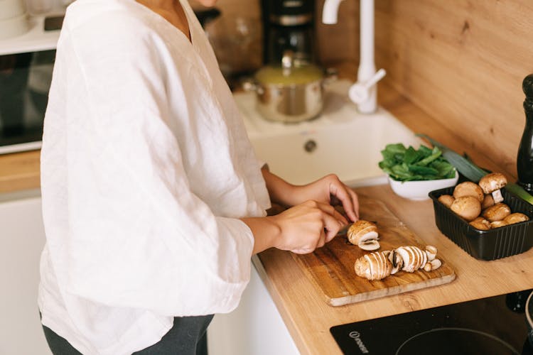 A Person Cutting Mushrooms 