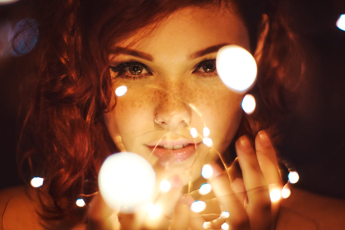 Free Photography of a Woman Holding Lights Stock Photo