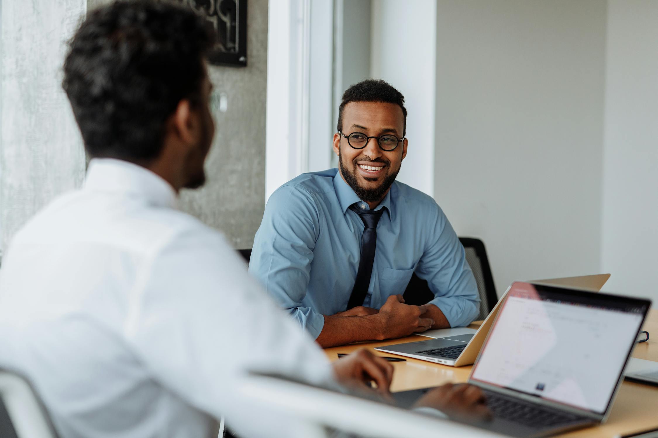 Business owners discussing options for acquiring an equipment financing loan