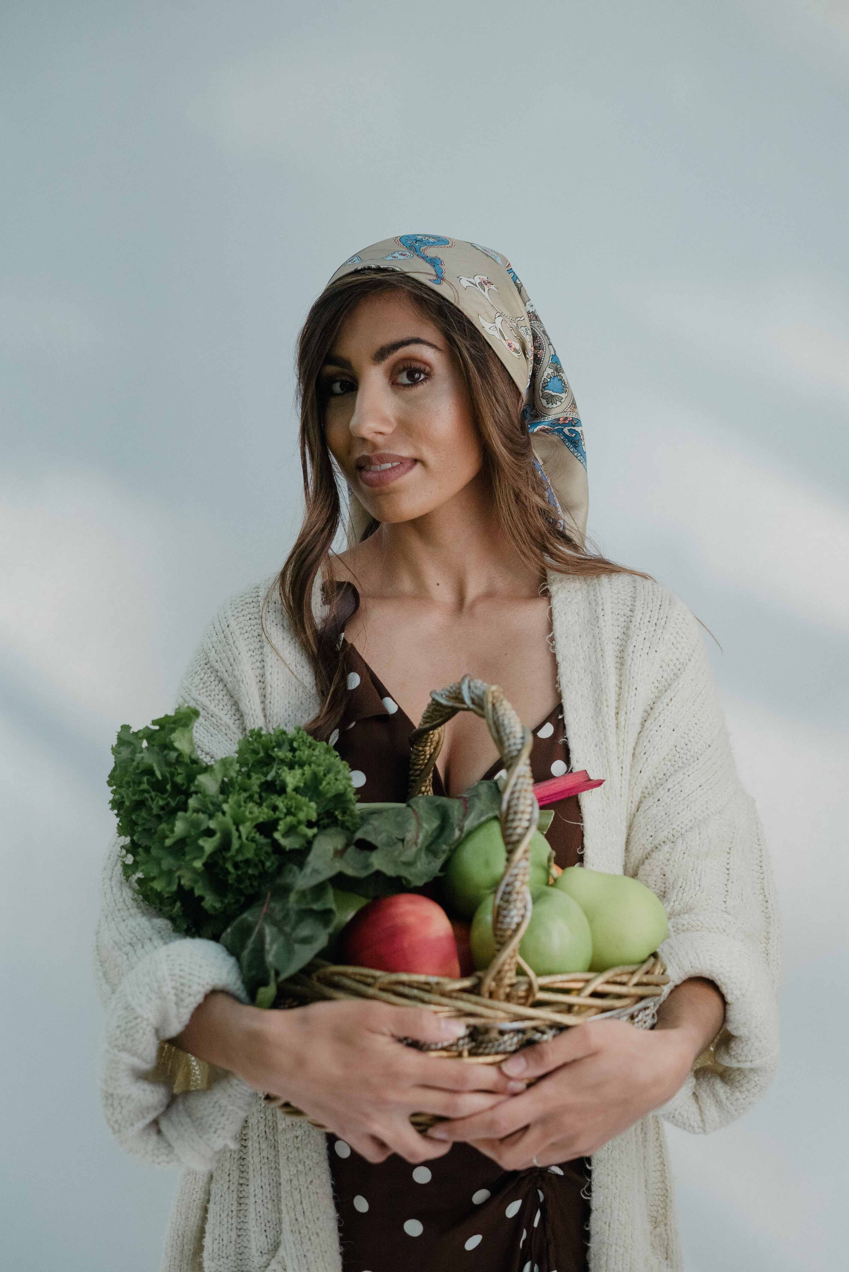 Woman Carrying a Basket of Fruits and Vegetables · Free Stock Photo