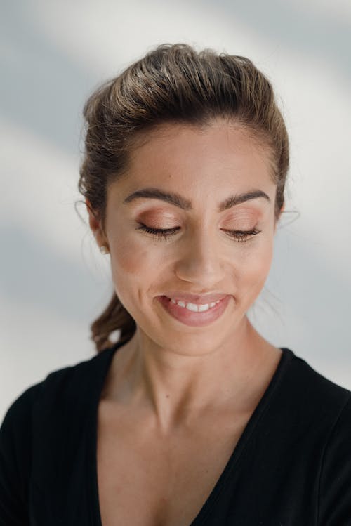 A Woman Wearing a Black Top Looking Down